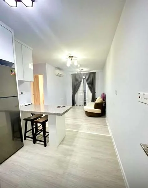 Kitchen features: white cabinetry, grey granite countertop, stainless-steel fridge, bar stools, pendant lighting; style: modern. Living features: light wood flooring, floor-to-ceiling windows, curtains, ceiling fan with light, accent chair, wall-mounted air conditioning unit; style: modern.