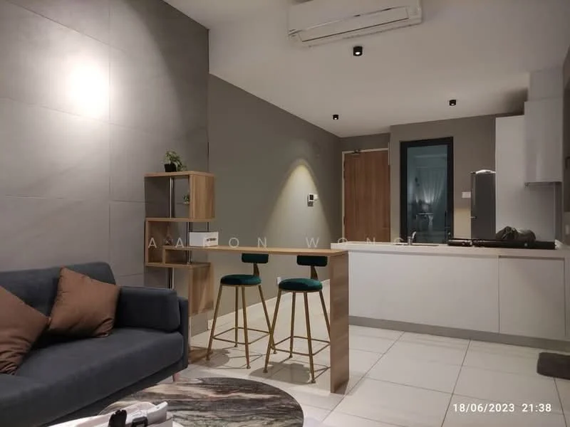Living features: grey fabric sofa, two brown accent pillows, marble coffee table, open shelving unit, bar counter with two stools, white cabinetry, stainless-steel kitchen appliances, recessed downlights, air conditioning unit, white tiled flooring, grey accent wall, wooden door, kitchen area visible in background; style: modern.