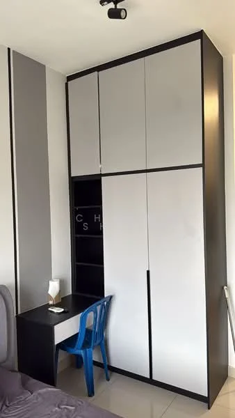 Room features: grey and black cabinetry, built-in wardrobe with sliding doors, desk with black surface, blue plastic chair, glossy tile flooring, wall-mounted light fixture, decorative wall paneling, neutral wall color; style: modern.
