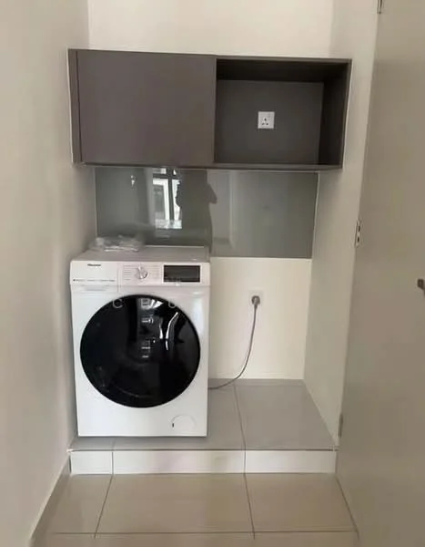 Laundry features: front-load washing machine in white, grey upper cabinetry, glass backsplash, white tiled flooring, single electrical outlet, neutral wall colour; style: modern.