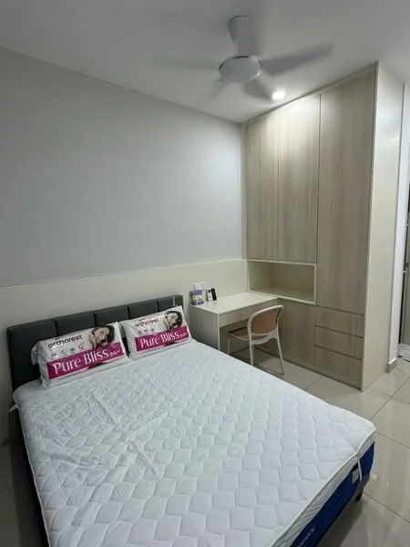 Bedroom features: queen-size bed with white mattress, upholstered headboard, 2 decorative pillows with text, built-in wardrobe with wood finish, study desk with chair, ceiling fan, recessed downlights, cream painted walls, glossy tile flooring; style: modern.