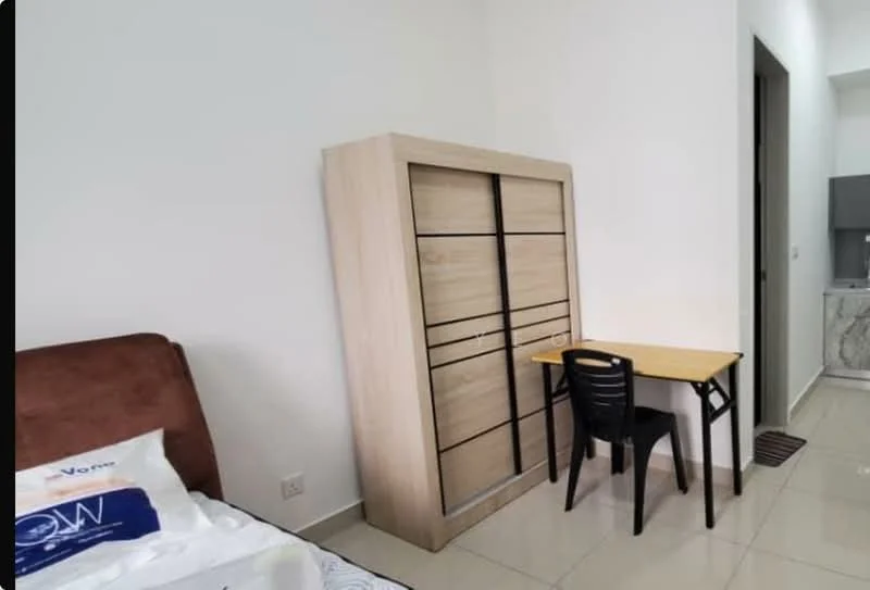 Bedroom features: queen-size bed with white bedding, wooden wardrobe with sliding doors, small study desk with black chair, white painted walls, glossy tile flooring, built-in cabinetry, doorway leading to another room, natural light from adjacent room; style: modern.