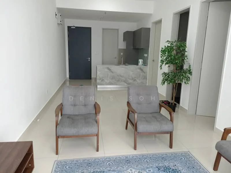 Living features: two grey fabric armchairs, wooden armrests, light-coloured wall, white ceiling, marble countertop in kitchen area, kettle on countertop, tile flooring, decorative plant in pot, area rug with geometric pattern, open layout to kitchen, doorway to other rooms; style: modern.