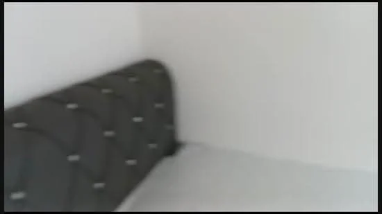 Room features: white painted walls, upholstered headboard in dark grey, bed with white bedding.