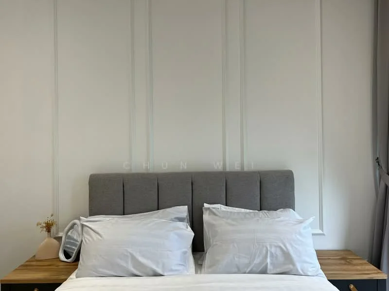 Bedroom features: grey upholstered headboard, white bedding, wooden bedside table, decorative vase with dried flowers, white painted walls, wall paneling, curtains, laminate flooring; style: modern.