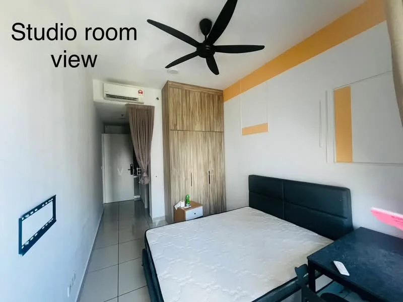 Bedroom features: black upholstered bed frame, mattress without bedding, ceiling fan with 5 blades, white painted walls, wooden wardrobe with sliding doors, grey tile flooring, small study desk, curtain on window, wall-mounted mirror, decorative wall panel in orange; style: modern.