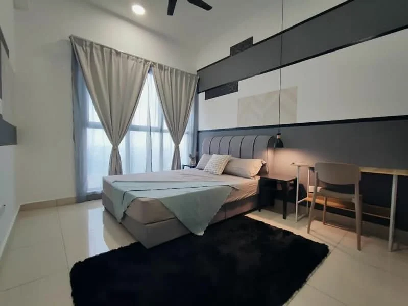 Bedroom features: king-size bed, upholstered headboard, bedside lamp, study desk, chair, floor-to-ceiling windows, sheer curtains, grey accent wall, white painted walls, recessed downlights, black area rug, tile flooring; style: modern; view: city.