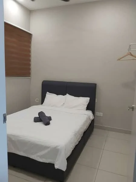 Bedroom features: queen-size bed with upholstered headboard, white bedding, two grey towels on bed, light grey painted walls, tile flooring, window with wooden blinds, hanging clothes rack, wall-mounted light fixture, door with handle; style: modern.