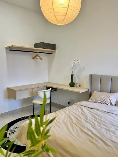 Bedroom features: queen-size bed with beige bedding, light grey upholstered headboard, white painted walls, light-colored flooring, hanging lamp, built-in desk with drawer, clothes hanger, decorative plant, wall-mounted clock, decorative vase with flowers; style: modern.