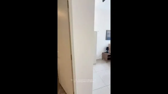 Room features: white painted walls, tile flooring, light-colored furniture, desk with chair, window with natural light, minimalist decor; style: modern.