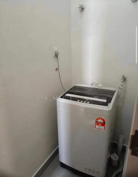 Laundry features: top-load washing machine, white appliance, water supply connections, drainage pipe, grey tiled flooring, plain white walls, power outlet.