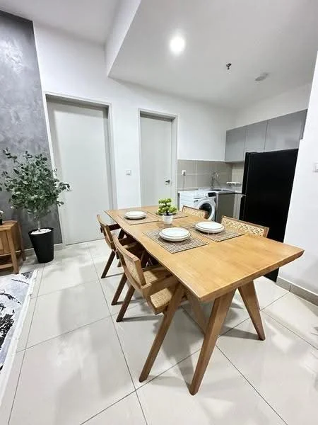 Dining features: wooden dining table, 4 dining chairs, table setting with plates, potted plant, light-colored tiled flooring, grey accent wall, white painted walls, recessed ceiling lights, kitchen cabinetry, washing machine, black refrigerator; style: modern.