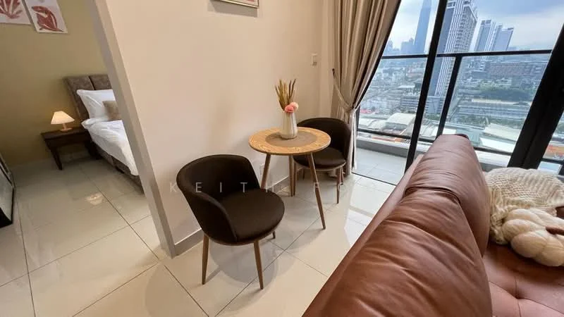 Living features: brown leather sofa, round wooden coffee table, two upholstered dining chairs, white bedding on bed, floor-to-ceiling windows, city skyline view, ceramic tile flooring, decorative vase with dried flowers; style: modern; view: city. Room features: white walls, soft lighting from lamp.