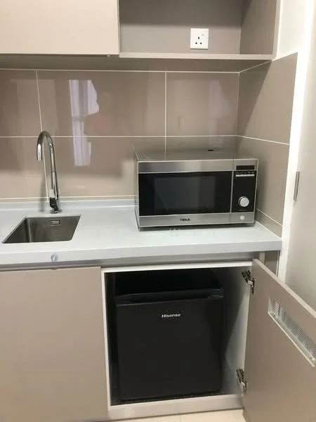Kitchen features: single-bowl stainless-steel sink, chrome pull-down faucet, light grey countertop, cream cabinetry, built-in microwave, black mini fridge, wall-mounted electrical outlet, tile backsplash, neutral wall tiles, under-cabinet lighting; style: modern.