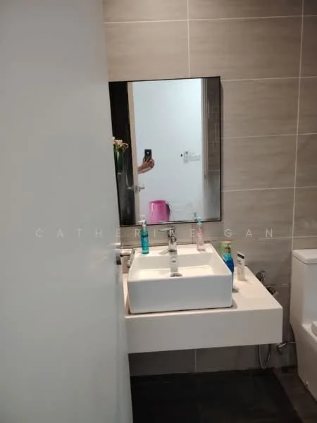 Bathroom features: white ceramic sink, chrome basin mixer faucet, large framed mirror, grey tiled walls, dark tiled flooring, toilet, bottle of hand soap, toothbrush holder, shower gel, facial cleanser; style: modern.