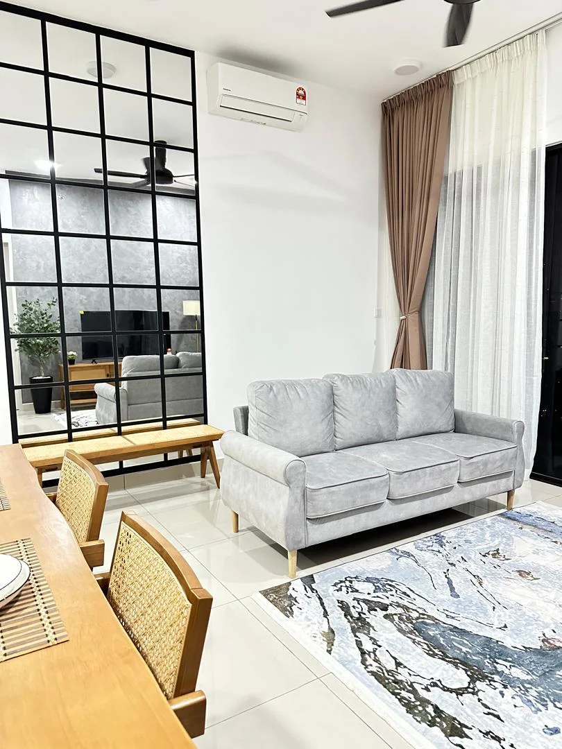 Living features: grey fabric 3-seater sofa, wooden coffee table, area rug with abstract pattern, floor-to-ceiling glass sliding door, sheer curtains, black ceiling fan, wall-mounted split AC, decorative plant in pot, TV console with television, mirrored wall panel, white painted walls, tile flooring; style: modern.