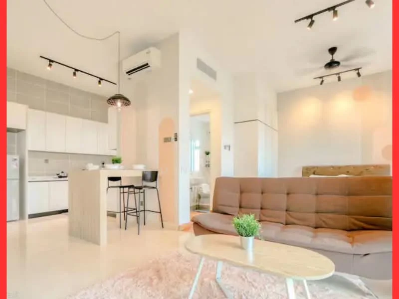 Living features: 3-seater fabric sofa in brown, coffee table, area rug with soft texture, ceiling fan, recessed downlights, wall-mounted air conditioning unit, open-plan layout, light-colored walls, large windows for natural light; style: modern. Kitchen features: white cabinetry, stainless-steel appliances, kitchen island with seating, ceramic tile flooring, grey backsplash, built-in oven, 4-burner gas hob, sink with faucet; style: modern. Bathroom features: white tiled walls, modern fixtures, glass shower enclosure, vanity with sink, mirror above vanity; style: modern.