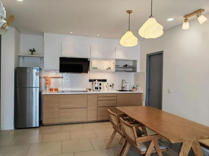 Kitchen features: white cabinetry with wood accents, stainless-steel fridge, built-in microwave, ceramic cooktop, stainless-steel sink, chrome pull-down faucet, white subway tile backsplash, wood dining table, wood dining chairs, pendant lighting, recessed downlights, tile flooring; style: modern.
