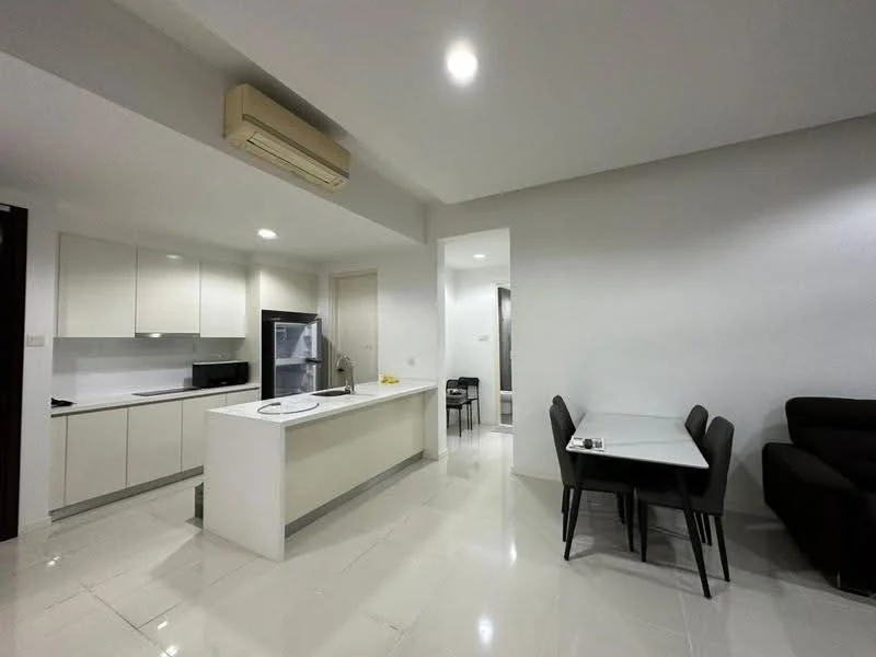 Kitchen features: white cabinetry, marble countertop, stainless-steel fridge, built-in oven, microwave, 4-burner gas hob, single-bowl stainless-steel sink, chrome pull-down faucet, recessed LED downlights, wall-mounted split AC, tile flooring, open layout to living area; style: modern. Dining features: 6-seater dining table, black dining chairs; style: modern. Living features: L-shape sectional sofa in dark color, tile flooring; style: modern.