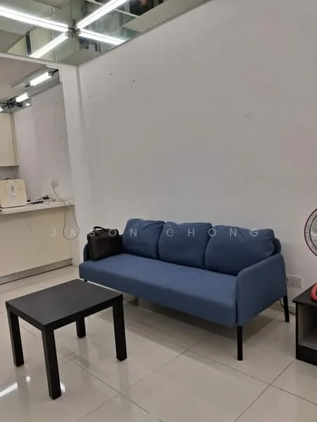 Living features: blue fabric sofa, black coffee table, white painted walls, glossy tile flooring, ceiling lights, mirror on wall, air conditioning unit, kitchenette visible in background; style: modern.