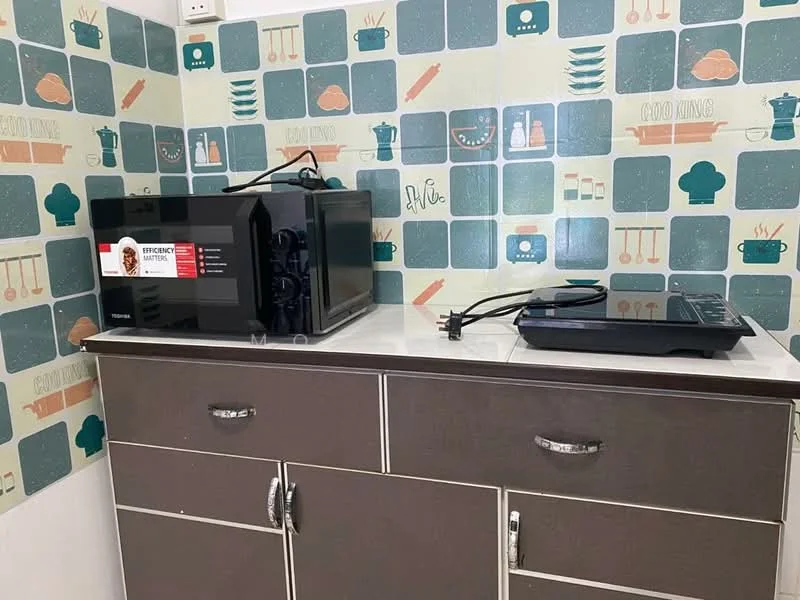 Kitchen features: microwave, digital kitchen scale, grey cabinetry, white countertop, decorative wallpaper with kitchen motifs, cabinets with handles, cooking utensils on wallpaper, plug socket on wall; style: modern.