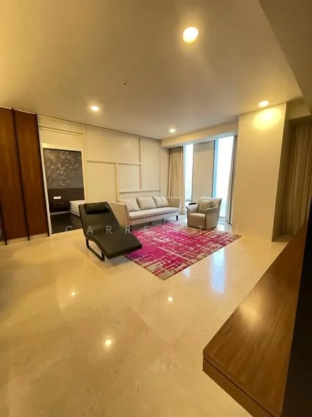 Living features: cream painted walls, marble flooring, floor-to-ceiling windows, sheer curtains, 3-seater fabric sofa in light grey, single armchair in light grey, area rug with geometric pattern in pink and white, wooden console table, decorative wall panel, recessed downlights; style: modern; view: city.