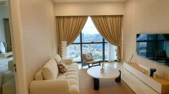 Living features: cream fabric sofa, round coffee table, floor-to-ceiling windows, sheer curtains, heavy drapes, wall-mounted TV, decorative vase, decorative artwork, area rug, city view; style: modern; view: city.