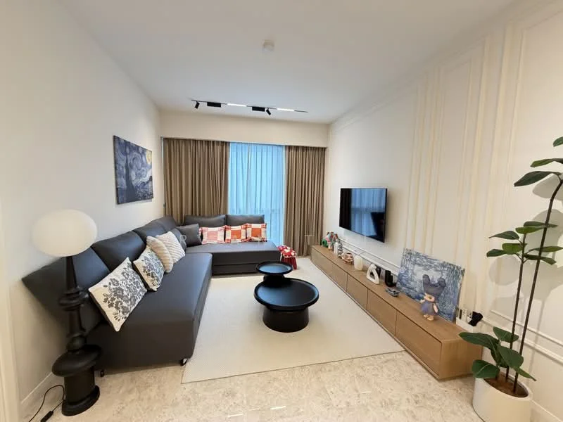 Living features: 3-seater fabric sofa in grey, decorative cushions in orange and white, black coffee table, light-colored area rug, wall-mounted TV, wooden TV console, decorative items on console, floor-to-ceiling windows with sheer curtains, curtains in beige, wall art with abstract design, plant in ceramic pot, recessed lighting, crown moulding on walls, marble tile flooring; style: modern.