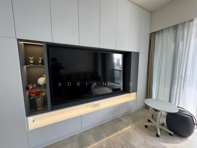 Living features: built-in cabinetry with grey finish, large wall-mounted TV, decorative shelving with display items, recessed lighting, light-colored stone flooring, floor-to-ceiling windows with sheer curtains, round side table, black accent chair; style: modern.