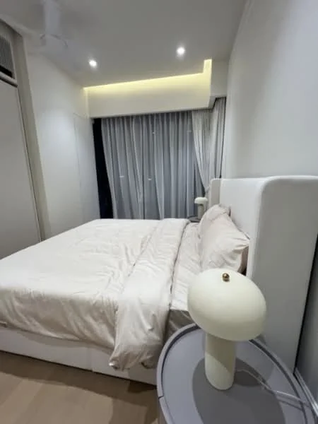 Bedroom features: king-size bed with upholstered headboard, white bedding, bedside lamp with round base, light wood bedside table, floor-to-ceiling windows with sheer curtains, recessed ceiling lights, light wood flooring, white painted walls, built-in wardrobe; style: modern.