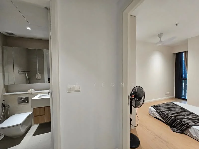 Room features: light wood flooring, white painted walls, ceiling fan, doorway leading to bathroom, mirror above vanity, vanity with sink, toilet, shower area, window with natural light, floor-to-ceiling window, bed with black and white bedding, standing fan; style: modern.
