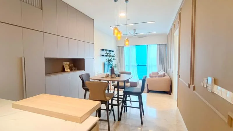 Living features: light grey walls, marble tile flooring, 5-blade ceiling fan with light, pendant lighting over dining table, sofa in light beige fabric, wooden dining table with 4 chairs, built-in cabinetry with light wood finish, floor-to-ceiling windows with sheer curtains, decorative plant on table, open-plan layout connecting kitchen and living area; style: modern; view: sea. Kitchen features: white cabinetry, light wood countertop, built-in appliances, open shelving, stainless-steel sink, chrome pull-down faucet; style: modern.