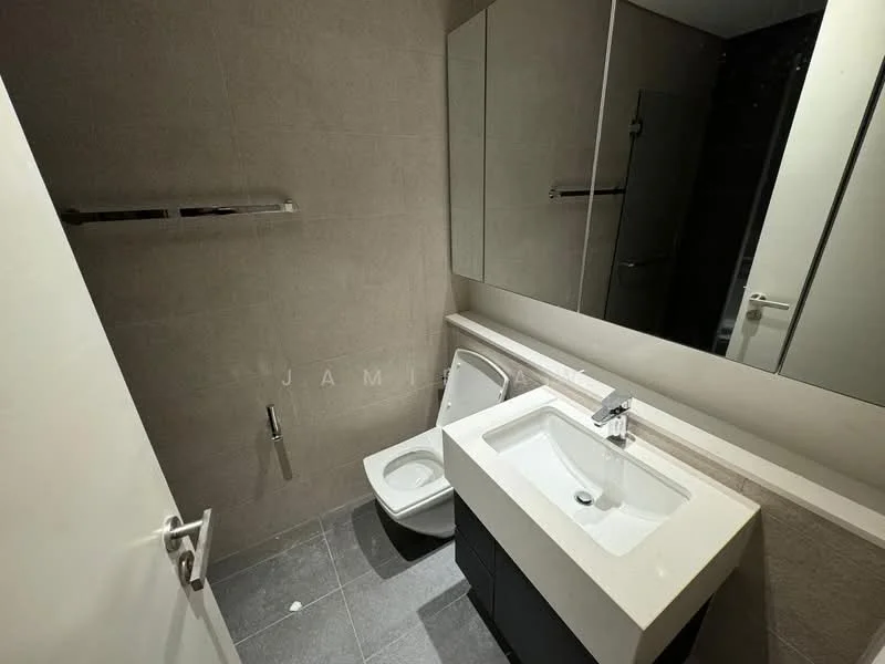 Bathroom features: grey tiled walls, dark grey floor tiles, single-sink vanity with white countertop, chrome basin mixer faucet, framed mirror, one-piece toilet, wall-mounted towel bar, recessed lighting; style: modern.