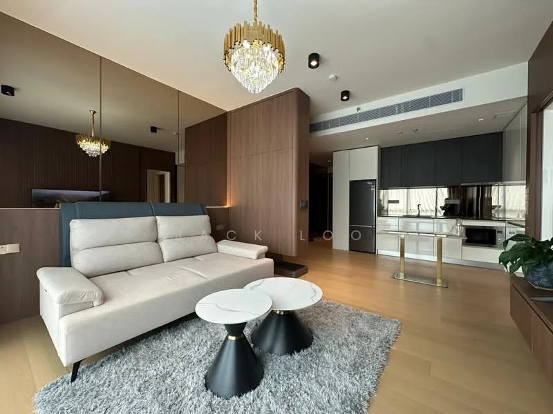 Living features: 3-seater fabric sofa in light grey, 2 round coffee tables with marble tops, area rug in light grey, chandelier with crystals, wall-mounted TV, wood paneling on walls, recessed downlights, floor-to-ceiling windows, open layout to kitchen, light wood flooring; style: modern. Kitchen features: stainless-steel fridge, built-in oven, freestanding range oven, white cabinetry, black countertop, open layout to living area; style: modern.
