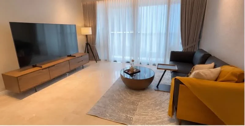 Living features: large flat-screen TV on wooden console, wooden console with drawers, grey fabric sofa, yellow throw blanket on sofa, round coffee table, area rug with geometric pattern, floor lamp with tripod base, sheer curtains, large windows, light-colored walls, marble tile flooring; style: modern.