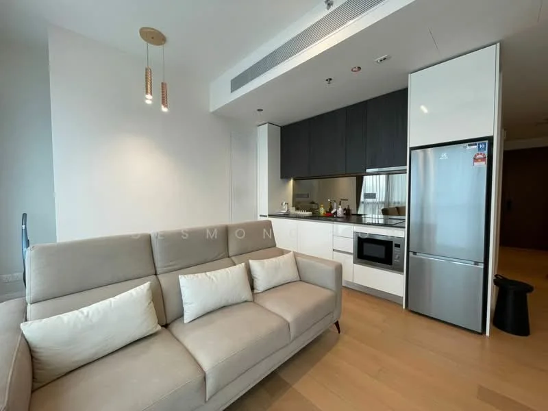 Living features: 3-seater fabric sofa in light grey, white throw pillows, light wood flooring, recessed downlights, pendant lighting with three bulbs, open kitchen layout, stainless-steel fridge, built-in microwave, white cabinetry, dark wood upper cabinets, kitchen countertop, kitchen backsplash, window with sheer curtains; style: modern.