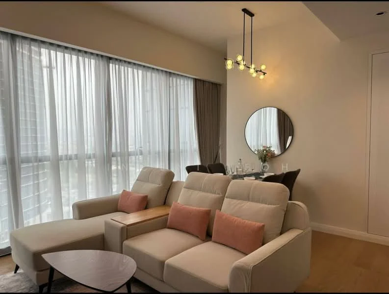 Living features: 2-seater fabric sofa in cream, 2 accent pillows in pink, round coffee table with dark wood top, chandelier with multiple bulbs, floor-to-ceiling windows with sheer curtains, wooden flooring, decorative round mirror, small vase with flowers on table, wall with neutral paint; style: modern; view: city.