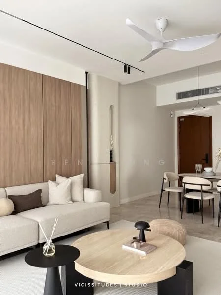 Living features: light-colored fabric sofa, round coffee table with wood top, black side table, ceiling fan with light, wood panel accent wall, recessed lighting, dining table with chairs, neutral color palette, large window, decorative vase on table, textured wall, flooring with light tiles; style: modern.
