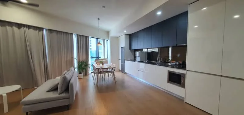 Living features: grey fabric sofa, white coffee table, dining table with wooden legs, 4 wooden dining chairs, floor-to-ceiling windows, sheer curtains, wooden flooring, pendant light fixture, kitchen cabinetry in black and white, built-in microwave, stainless-steel sink, chrome faucet, kitchen countertop, recessed downlights; style: modern; view: city.