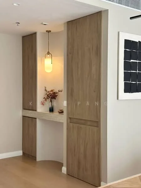 Room features: light wood cabinetry, stone countertop, pendant light fixture, neutral wall color, laminate flooring, decorative vase with flowers, framed artwork on wall; style: modern.