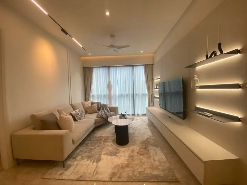Living features: 3-seater fabric sofa in beige, decorative cushions, coffee table with black base, area rug with neutral tones, wall-mounted TV, floating shelves with ambient lighting, recessed ceiling lights, ceiling fan, floor-to-ceiling windows with sheer curtains, light-colored walls, neutral-toned flooring; style: modern.