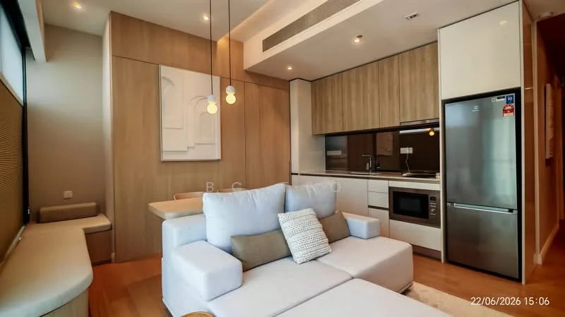 Living features: light wood panelled walls, white painted walls, light wood flooring, sofa in light grey fabric, coffee table, wall-mounted TV, built-in cabinetry, stainless-steel fridge, built-in oven, microwave, pendant lighting, dining table for four, large window with city view; style: modern; view: city.