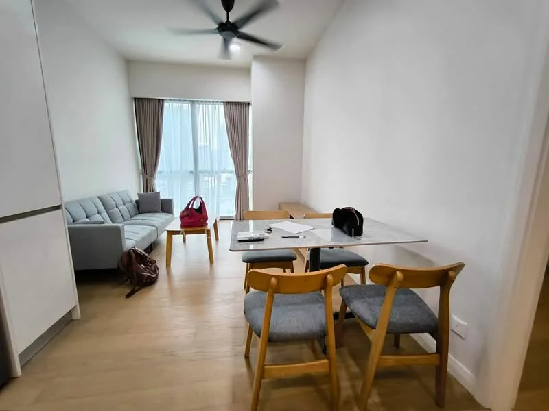 Living features: 3-seater fabric sofa in light grey, wooden dining table, 2 wooden dining chairs with grey upholstery, floor-to-ceiling windows, curtains in light beige, light wood flooring, ceiling fan, decorative wall with white painted walls, laptop on table, backpack on floor; style: modern; view: city.