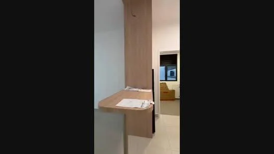 Room features: wooden countertop, white walls, light-colored cabinetry, tile flooring, open space, natural light from window, minimalist design; style: modern.