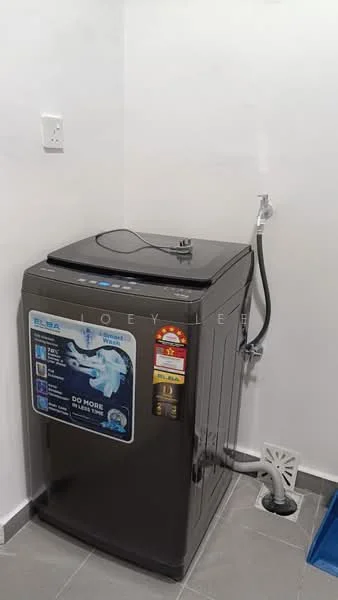 Laundry features: top-load washing machine in grey, water inlet hose, drain hose, grey tiled flooring, white painted walls, power outlet, floor drain.