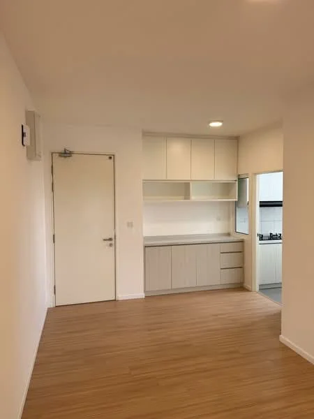 Kitchen features: light wood cabinetry, white countertop, built-in kitchen appliances, stainless-steel sink, single-bowl sink, chrome faucet, open shelving, laminate flooring, white walls, recessed downlights; style: modern. Room features: light wood flooring, white walls, door to hallway, air conditioning unit.