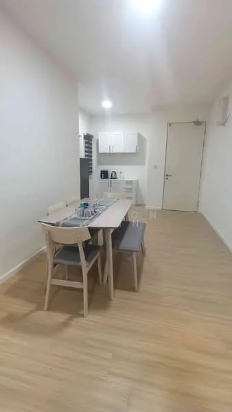 Kitchen features: light wood flooring, white painted walls, ceiling lights, kitchen cabinets with white finish, stainless-steel sink, countertop, dining table with chairs, microwave, refrigerator, kettle; style: modern.