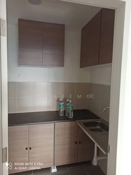 Kitchen features: laminate cabinetry in light brown, black countertop, stainless-steel sink, chrome faucet, wall-mounted cabinets, tile backsplash, grey floor tiles, three bottled water bottles on countertop; style: modern.