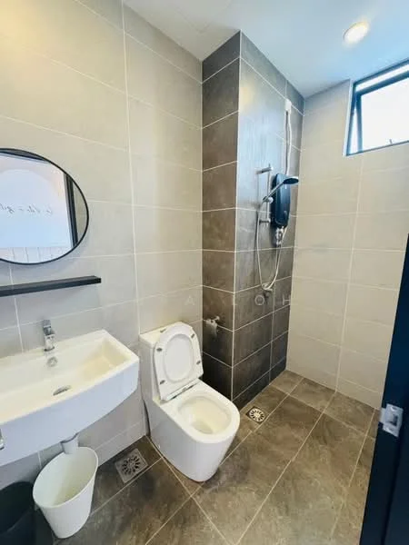 Bathroom features: wall-mounted sink with chrome faucet, round framed mirror, one-piece toilet, walk-in shower with glass partition, rain shower head, handheld shower, grey ceramic tile walls, dark grey ceramic tile flooring, window for natural light, shower control panel, waste bin; style: modern.