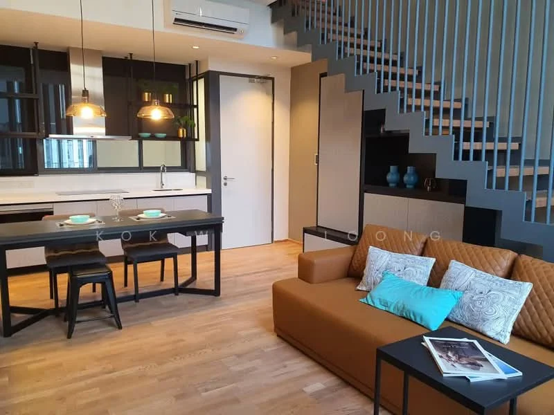 Living features: brown leather sofa, decorative cushions, black coffee table, wooden flooring, pendant lighting, open staircase with metal railing, wall-mounted air conditioning unit, kitchenette with countertop, black dining table with two stools, glass vase on shelf, wall-mounted decor, white painted walls; style: modern.
